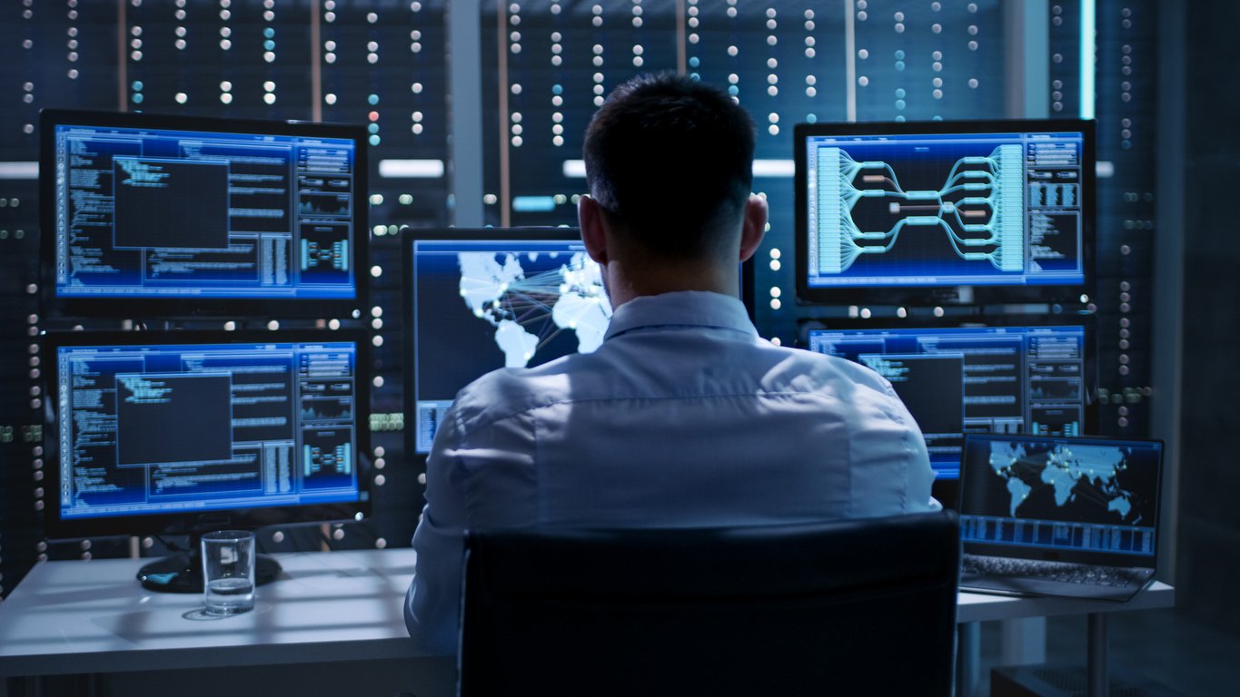system-security-specialist-working-at-system-control-center-room-is-full-of-screens-displaying-various-information